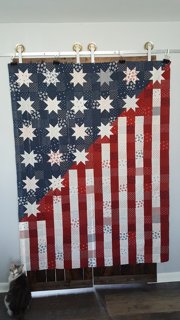 Our Flag Stands for Freedom Quilt hanging on wall